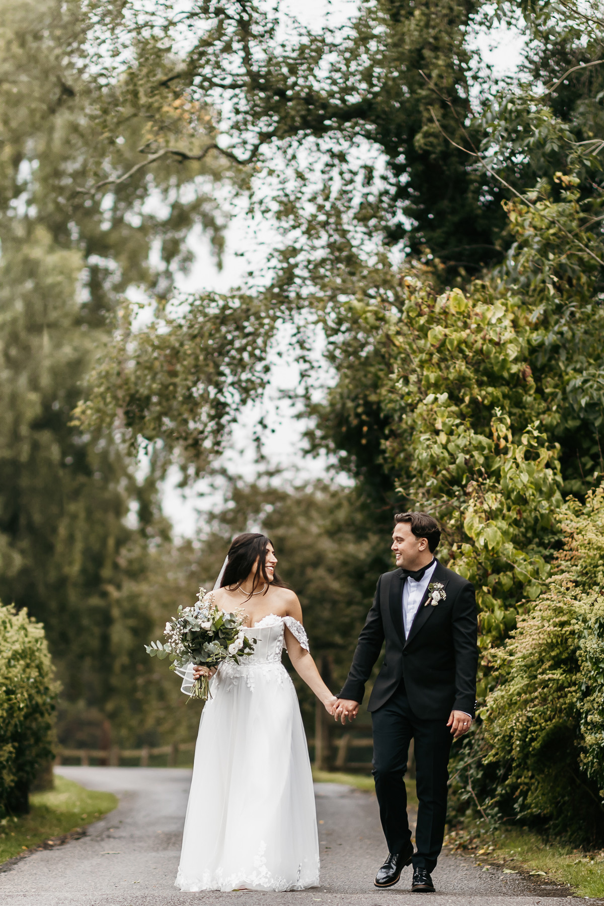 Bride and Groom walking hand in hand having their wedding photos taken by a Berkshire wedding photographer