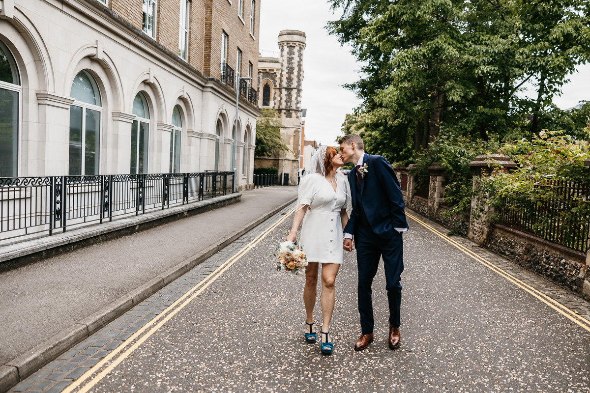 Newly married wedding couple having a walk through a Berkshire town having their photos taken 