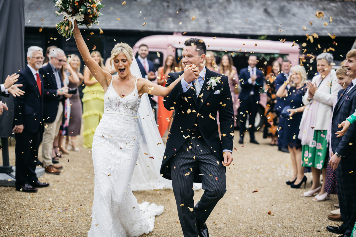 A Berkshire wedding with a newly married couple having confetti thrown at them after their ceremony 